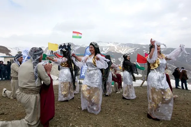 Kurdish dancers perform during the Kurdistan Ice and snow festival held at Kudu Mountain near the Iraq-Iran border town of Haj Omran, in the autonomous Kurdistan region of Iraq, February 20, 2016. (Photo by Azad Lashkari/Reuters)