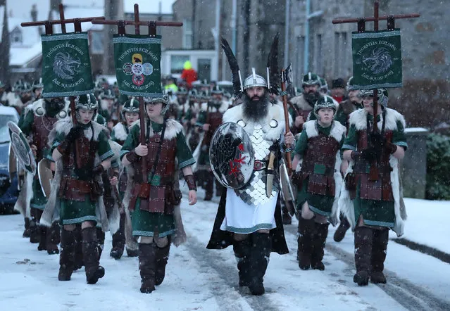 Guizer Jarl, John Nicholson (in white) leads his squad through the streets of Lerwick, Shetland Islands on January 29, 2019 before the Up Helly Aa festival later in the day. Up Helly Aa celebrates the influence of the Scandinavian Vikings in the Shetland Islands and culminates with up to 1,000 “guizers” (men in costume) throwing flaming torches into their Viking longboat and setting it alight later in the evening. (Photo by Andrew Milligan/PA Wire Press Association)