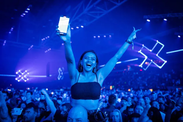 A woman cheers during the Amsterdam Music Festival at Johan Cruijff ArenA in Amsterdam on early October 23, 2022. (Photo by Marco de Swart/ANP via AFP Photo)