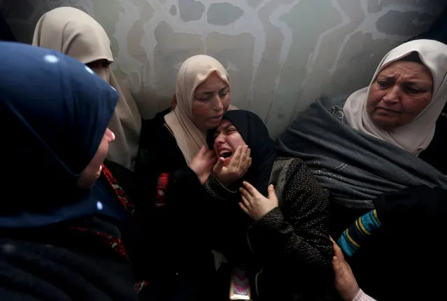 Relatives of Palestinian teen Hassan Shalabi, 14, who was killed during a protest at the Israeli-Gaza border fence, mourn during his funeral in the central Gaza Strip February 9, 2019. (Photo by Ibraheem Abu Mustafa/Reuters)