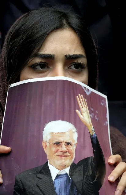 A supporter of Iranian former vice-president Mohammad Reza Aref, a candidate for the upcoming parliamentary elections, holds his picture during a reformist campaign in Tehran February 20, 2016. (Photo by Raheb Homavandi/Reuters/TIMA)