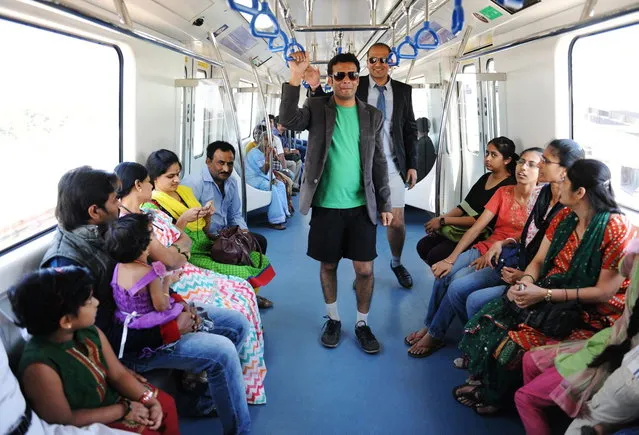Indian commuters, stripped to their underpants, participate in a No Pants Subway Ride on the metro in Bangalore on January 12, 2014. The No Pants Subway Ride is an annual event staged across major cities of the World every January. (Photo by AFP Photo)