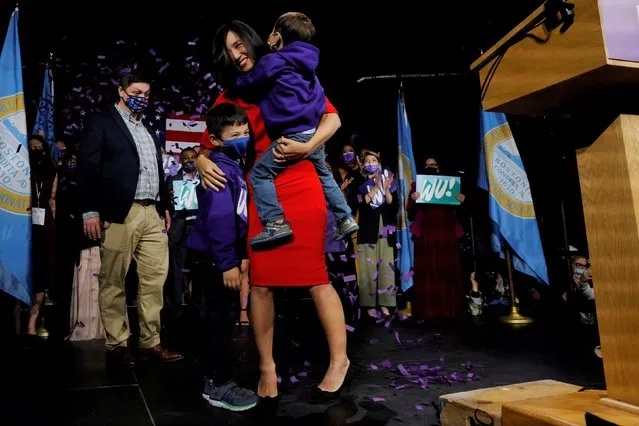 Michelle Wu hugs her children Cass and Blaise after winning her race for Mayor of Boston, to become the first woman and first person of color to be elected to the office, in Boston, Massachusetts, U.S., November 2, 2021. (Photo by Brian Snyder/Reuters)