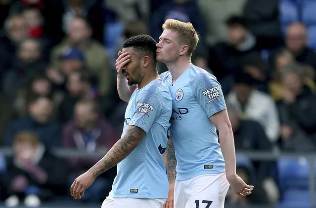 Manchester City's Gabriel Jesus, left, celebrates scoring his side's third goal of the game with teammate Kevin De Bruyne, during the English Premier League soccer match between Crystal Palace and Manchester United,  at Selhurst Park, in London, Sunday April 14, 2019. (Photo by Steven Paston/PA Wire via AP Photo)