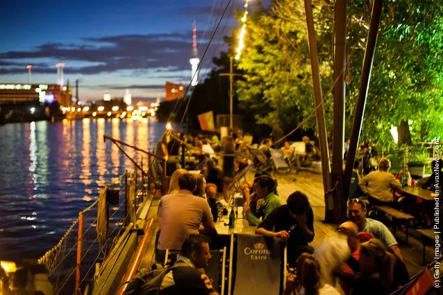 Guests spend the evening in the beach bars in Berlin, Germany