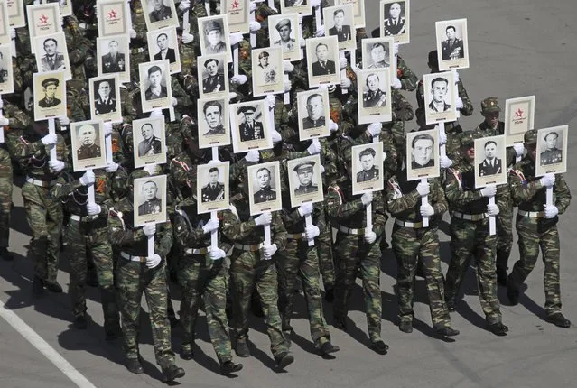 People hold pictures of World War Two soldiers as they take part in the Immortal Regiment march during the Victory Day celebrations in Barnaul, Russia, May 9, 2015. (Photo by Andrei Kasprishin/Reuters)