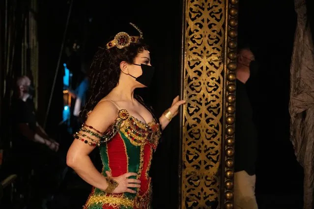 Actor Meghan Picerno, dressed as her character “Christine Daae”, looks on from the wings of the stage during a final dress rehearsal ahead of the reopening of “The Phantom of the Opera” at the Majestic Theater in New York, U.S., October 19, 2021. (Photo by Caitlin Ochs/Reuters)