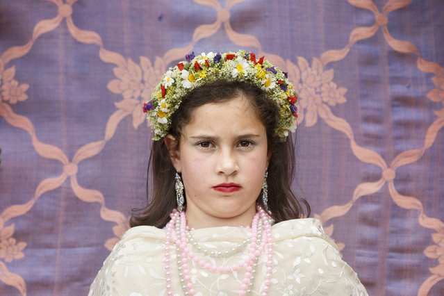 A “Maya” girl sits in an altar during the traditional celebration of “Las Mayas” on the streets in Colmenar Viejo, near Madrid, Spain Saturday, May 2, 2015. (Photo by Daniel Ochoa de Olza/AP Photo)