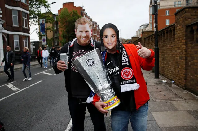Eintracht Frankfurt fans pose wearing masks of Britain's Prince Harry and Meghan Duchess of Sussex while holding a replica trophy outside the stadium before the UEFA Europa League Semi Final Second Leg match between Chelsea and Eintracht Frankfurt at Stamford Bridge on May 9, 2019 in London, England. (Photo by David Klein/Reuters)