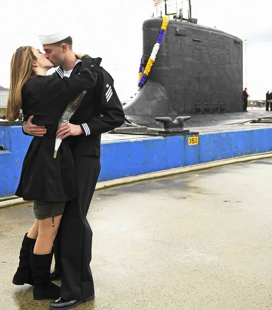 U.S. Navy Seaman Kyle Hodgson kisses Steffanie Dube as the Virginia-class attack submarine USS Minnesota (SSN 783) returns to the Navy submarine base in Groton, Conn., Friday, November 26, 2021, following a nearly seven-month deployment. (Photo by Sean D. Elliot/The Day via AP Photo)