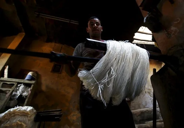 Hisham Aly, 37, works on yarns at a dye workshop in old Cairo, Egypt, March 17, 2016. (Photo by Amr Abdallah Dalsh/Reuters)