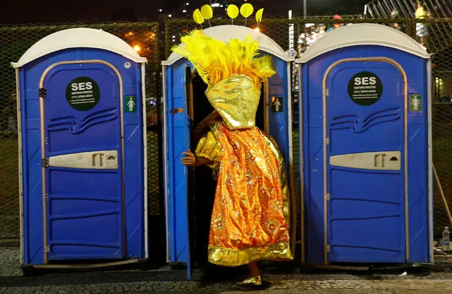 A reveller enters a chemical toilet before the first night of the Carnival parade of samba schools at the Sambadrome in Rio de Janeiro, Brazil, February 26, 2017. (Photo by Ricardo Moraes/Reuters)