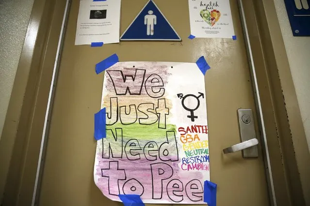 A protest sign on a bathroom which helped lobby for the first gender-neutral restroom in the Los Angeles school district is seen at Santee Education Complex high school in Los Angeles, California, U.S., April 18, 2016. (Photo by Lucy Nicholson/Reuters)