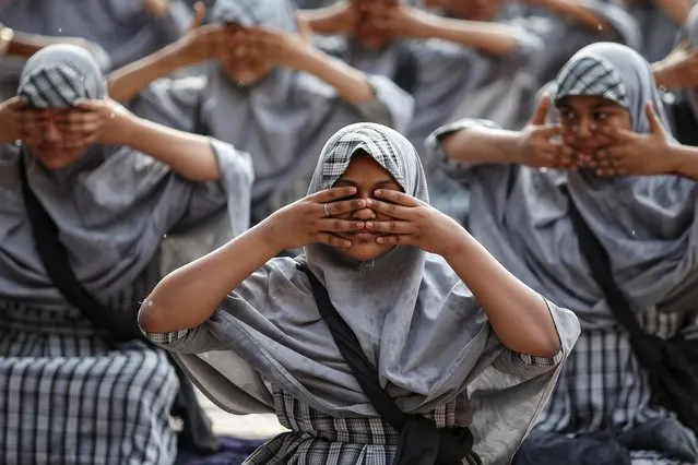 Muslim students attend a yoga lesson at a school ahead of International Yoga Day in Ahmedabad, India, June 18, 2019. (Photo by Amit Dave/Reuters)