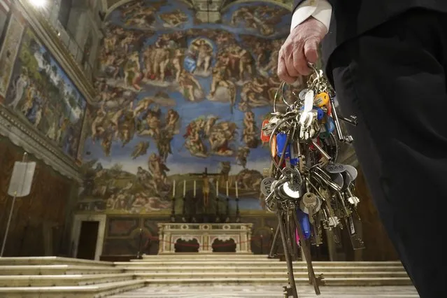 Gianni Crea, the Vatican Museums chief "Clavigero" keys keeper walks through the Sistine Chapel as he prepares to open the museum, at the Vatican, Monday, February 1, 2021. The Vatican Museums reopened Monday to visitors after 88 days of shutdown following COVID-19 containment measures. (Photo by Andrew Medichini/AP Photo)