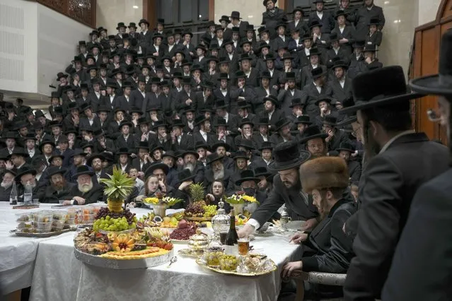 Ultra-Orthodox Jews of the Sadigura Hasidic dynasty celebrate the Jewish feast of “Tu Bishvat” or “New Year of the Trees”. as they sit with their rabbis around a long table filled with all kinds of fruits, in the ultra-Orthodox town of Bnei Brak, Israel, Sunday, January 16, 2022. (Photo by Ariel Schalit/AP Photo)