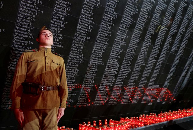 A participant dressed in a historical uniform stands at attention during a ceremony, which is part of the Memory Candle campaign dedicated to the 79th anniversary of the victory over Nazi Germany in World War Two, in Simferopol, Crimea on May 7, 2024. (Photo by Alexey Pavlishak/Reuters)
