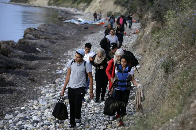 Syrian migrants arrive from Turkish coasts at a beach in Mytilene, on the northeastern Greek island of Lesvos, early Tuesday, June 16, 2015. Lesvos has been bearing the brunt of a huge influx of migrants from the Middle East, Asia and Africa crossing from the Turkish coast to nearby Greek islands. More than 50,000 migrants have arrived in Greece already this year, compared to 6,500 in the first five months of last year. (AP Photo/Thanassis Stavrakis)