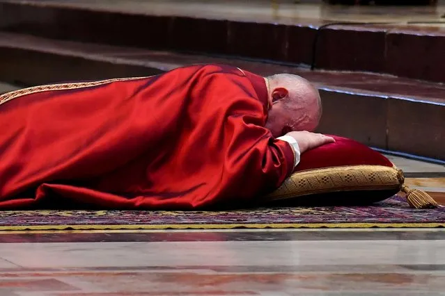 Pope Francis lies down in prayer prior Good Friday celebrations for the Passion of the Lord, at St. Peter's Basilica in the Vatican, April 2, 2021. (Photo by Andreas Solaro/Pool via Reuters)