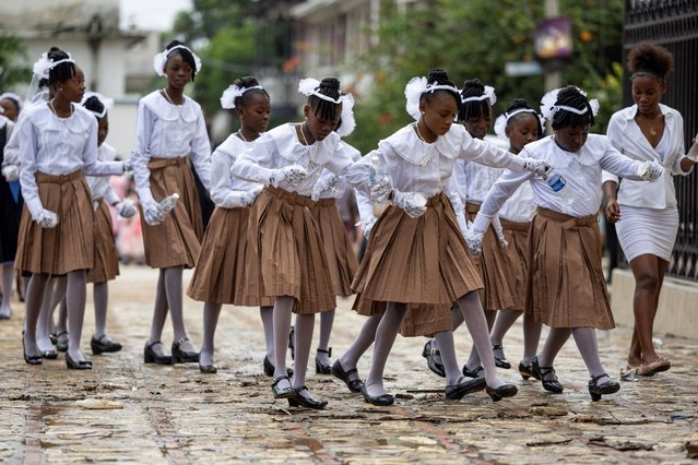 A group of girls arrive at the Our Lady of the Assumption Cathedral for their confirmation ceremony in Cap-Haitien, Haiti on April 28, 2024. (Photo by Ricardo Arduengo/Reuters)