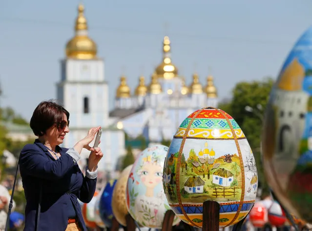 A woman takes a picture of a traditional Ukrainian Easter egg “Pysanka”, installed as part of the upcoming celebrations of Easter, in central Kiev, Ukraine, April 29, 2016. (Photo by Valentyn Ogirenko/Reuters)