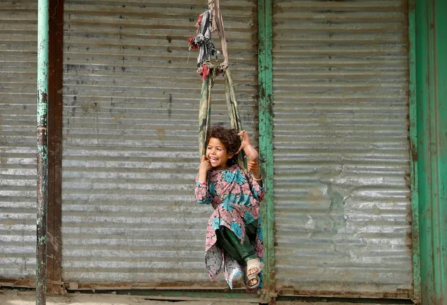 An Afghan girl plays on a swing in Kabul, Afghanistan on June 24, 2019. (Photo by Mohammad Ismail/Reuters)