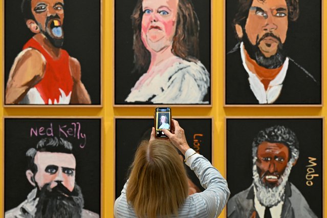 A visitor takes a picture of a portrait of Australian billionaire Gina Rinehart, which forms part of an artwork titled “Australia in Colour, 2021” by artist Vincent Namatjira at the National Gallery of Australia, in Canberra, Australia, 17 May 2024. (Photo by Lukas Coch/EPA)