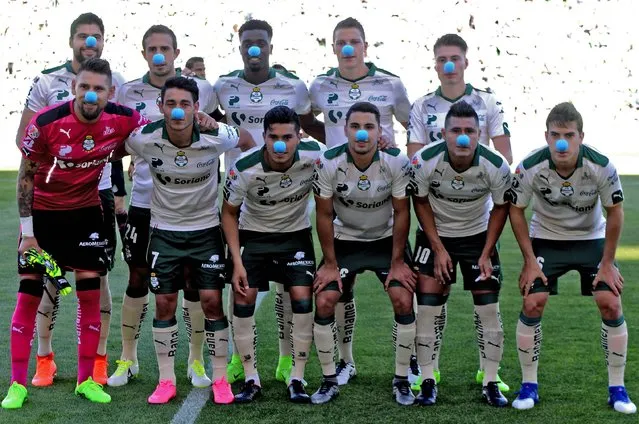 Santos players wear a blue nose in support of World Autism Awareness Day while participating in protocol events prior to their Mexican Clausura 2017 Tournament football match against Queretaro at TSM Corona stadium on April 2, 2017, in Torreon, Mexico. (Photo by Oscar Wong/AFP Photo)
