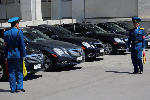 Policemen stand in front of black Mercedes-Benz sedans, with the 727 number plates, reserved for the highest government officials, outside the People's Palace of Culture in central Pyongyang, North Korea May 8, 2016. (Photo by Damir Sagolj/Reuters)