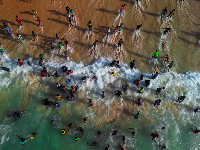 An aerial view of Senegalese people spending their spare time at the Yoff beach, one of the most popular weekend destinations for locals, as summer days have approached in Dakar, Senegal on May 18, 2024. (Photo by Cem Ozdel/Anadolu via Getty Images)