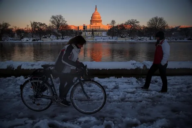 The U.S. Capitol is seen at sunset following a winter storm along the National Mall in Washington, U.S., January 3, 2022. (Photo by Tom Brenner/Reuters)