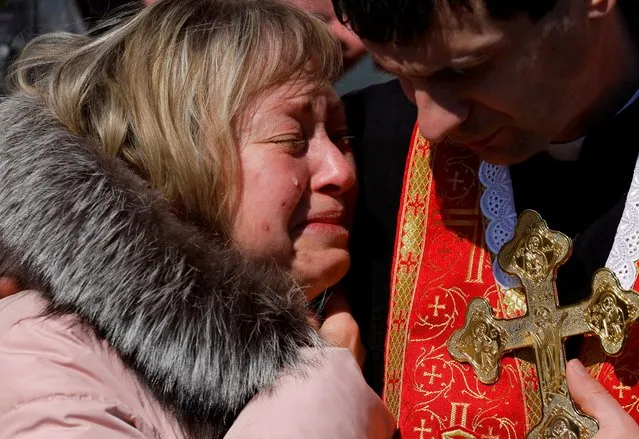 Olena, the mother of Denys Snihur, 25, a border guard-turned-soldier, killed by Russian shelling in the northern town of Ovruch, mourns her son during his funeral at the Lychakiv cemetery, in Lviv, Ukraine, March 21, 2022. (Photo by Zohra Bensemra/Reuters)