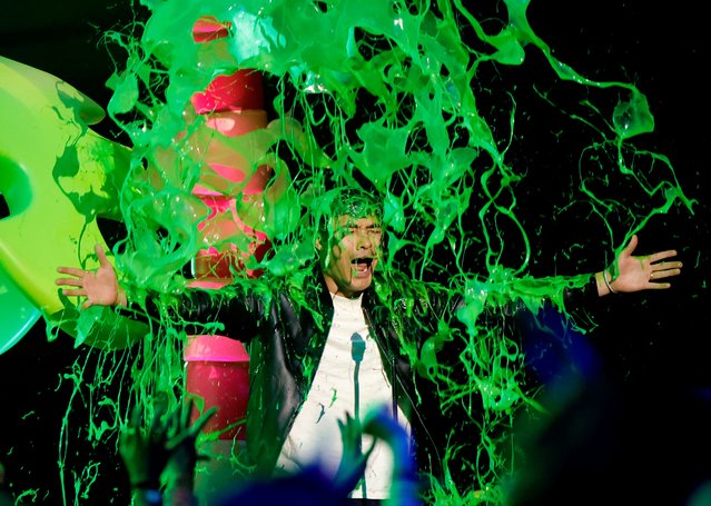 British actor and former TV show host Henry Golding gets slimed while speaking onstage during Nickelodeon Kids' Choice Awards 2024 at Barker Hangar on July 13, 2024 in Santa Monica, California. (Photo by Emma McIntyre/Getty Images for Nickelodeon)