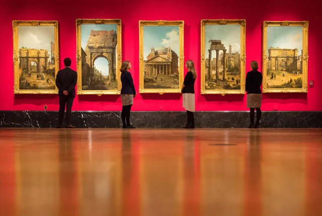 Visitors look at Canaletto's paintings of Roman views at the Queen's Gallery at Buckingham Palace in London, Thursday, May 18, 2017. A new exhibition reunites two of Canaletto's finest sets of paintings, displayed side by side for the first time in almost 40 years. Canaletto & the Art of Venice is opening on May 19, at The Queen's Gallery, Buckingham Palace. (Photo by Dominic Lipinski/PA Wire)