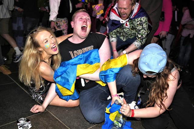 Swedish Eurovision fans in the Fan Zone react as Loreen of Sweden wins Grand Final of the Eurovision Song Contest in Liverpool, England, Saturday, May 13, 2023. (Photo by Jon Super/AP Photo)