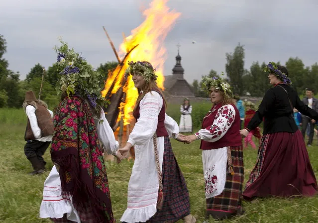 People take part in the Ivan Kupala festival near the village of Ozertso, on the outskirts of Minsk June 20, 2015. (Photo by Vasily Fedosenko/Reuters)