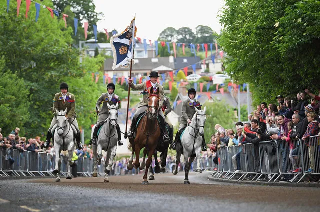 Standard bearer Kieran Riddell and his attendants arrive back in the town as they take part in the town's Common Riding, one of the oldest Borders festivals on June 16, 2017 in Selkirk, Scotland. The event dating from the Battle of Flodden in 1513, remembers the story of Flodden, when Selkirk sent 80 men into battle with the Scottish King. One man returned, bearing a blood stained English flag. (Photo by Jeff J. Mitchell/Getty Images)