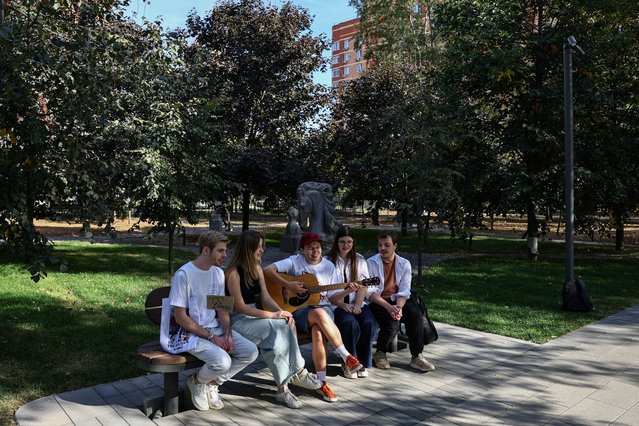 Fans of Taylor Swift sing with a guitar in a park in Lyubertsy outside Moscow, Russia on September 15, 2024. (Photo by Evgenia Novozhenina/Reuters)