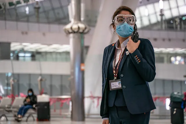A MTR staff wearing protective goggles and mask stands by in the departure hall at Hong Kong High Speed Rail Station on January 29, 2020 in Hong Kong, China. Hong Kong government will deny entry for travellers who has been to Hubei province except for local residents in response to tighten the international travel and border crossing to stop the spread of the virus. (Photo by Anthony Kwan/Getty Images)