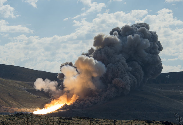 A handout image released by NASA on 28 June 2016 shows the second and final qualification motor (QM-2) test for the Space Launch System's booster, at Orbital ATK Propulsion Systems test facilities in Promontory, Utah, USA, 28 June 2016. During the Space Launch System flight the boosters will provide more than 75 percent of the thrust needed to escape the gravitational pull of the Earth, the first step on NASA's Journey to Mars. (Photo by Bill Ingalls/EPA/NASA)