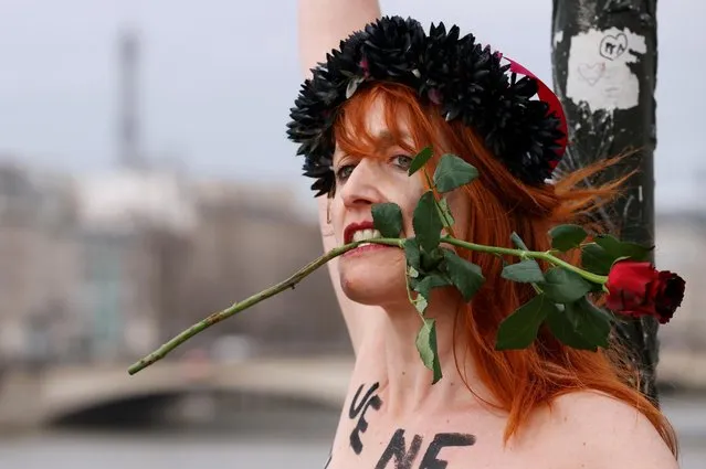 A Femen activist stages an action on the Pont des Arts to protest violence against women on Valentine's Day in Paris, France, February 14, 2020. (Photo by Christian Hartmann/Reuters)
