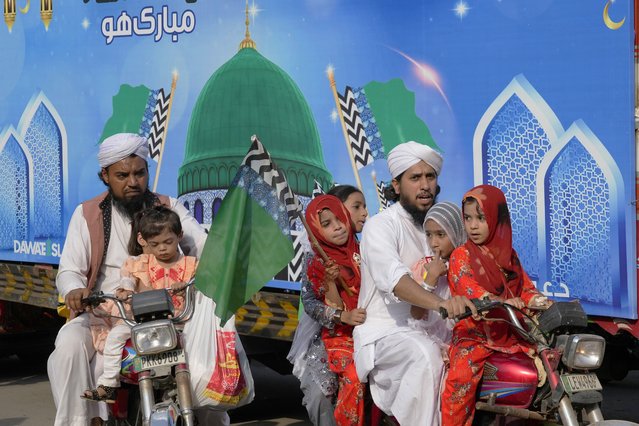 Supporters of a religious group 'Dawat-e-Islami with their children take part in a rally for Mawlid al-Nabi holiday celebrating the birthday of Islam's prophet, Muhammad, born in the year 570, in Lahore, Pakistan, Tuesday, September 17, 2024. (Photo by K.M. Chaudary/AP Photo)