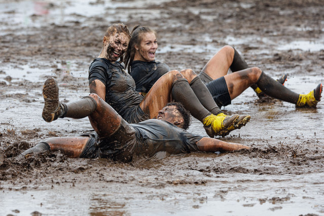 Competitors react during the 2023 German Mud Football Championships on August 5, 20234 in Woellnau, Germany. Twelve men's and two women's teams are competing this year for the championship titles. (Photo by Jens Schlueter/Getty Images)