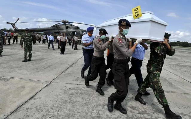 Indonesian security forces carry a coffin containing the remains of a passenger recovered from the crash site of the Trigana Air passenger plane at Sentani Airport, near Jayapura, Papua province, Indonesia, August 20, 2015 in this photo taken by Antara Foto. (Photo by Andika Wahyu/Reuters/Antara Foto)