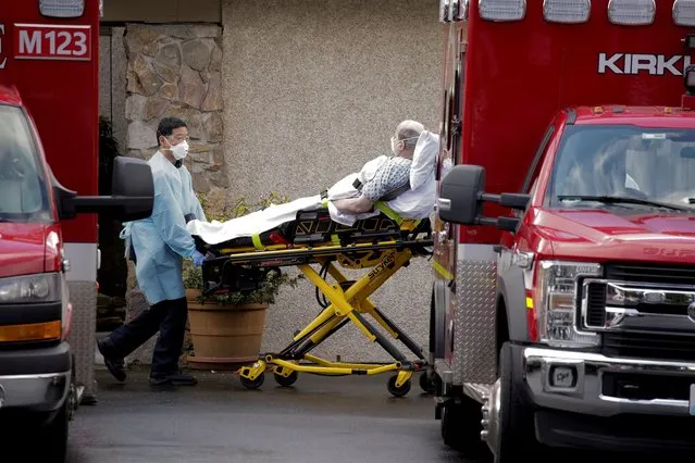 Medics transport a man on a stretcher into an ambulance at the Life Care Center of Kirkland, a long-term care facility linked to several confirmed coronavirus cases, in Kirkland, Washington, U.S. March 3, 2020. (Photo by David Ryder/Reuters)