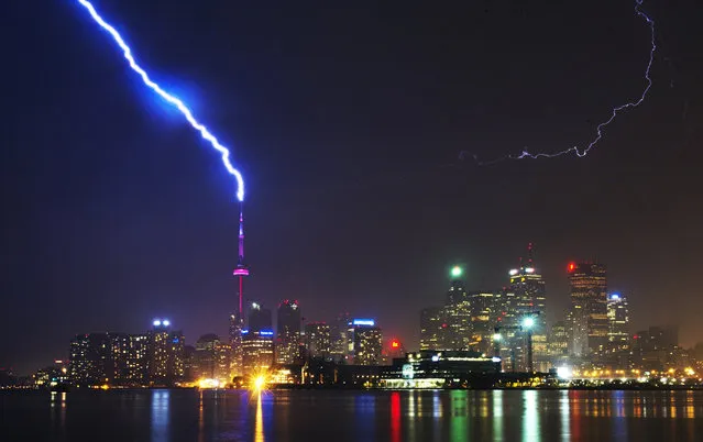 Lightning strikes the CN Tower during a thunderstorm in Toronto May 29, 2011. (Photo by Mark Blinch/Reuters)
