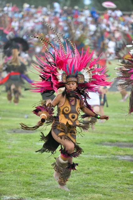 Dancers of Pre-Hispanic traditional dances perform while attempting to set a Guinness Record of “The biggest Ceremonial Dance of the world”, near the Teotihuacan archaeological site, Mexico, on July 17, 2016. (Photo by Mario Vazquez/AFP Photo)