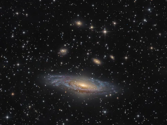 “Galaxies”. Runner up: NGC 7331 – The Deer Lick Group by Bernard Miller (USA) NGC 7331 is an unbarred spiral galaxy found some 40 million light years away from Earth, in the constellation Pegasus. Of the group of galaxies known as the Deer Lick Group, NGC 7331 is the largest, and can be seen dominating the image whilst the smaller galaxies NGC 7335, NGC 7336, NGC 7337, NGC 7338 and NGC 7340 drift above it. Animas, New Mexico, USA, 30 October 2016 PlaneWave CDK-17 17-inch reflector telescope at f/6.8, Paramount ME mount, Apogee CG16M camera, 18-hour total exposure. (Photo by Bernard Miller/Insight Astronomy Photographer of the Year 2017)