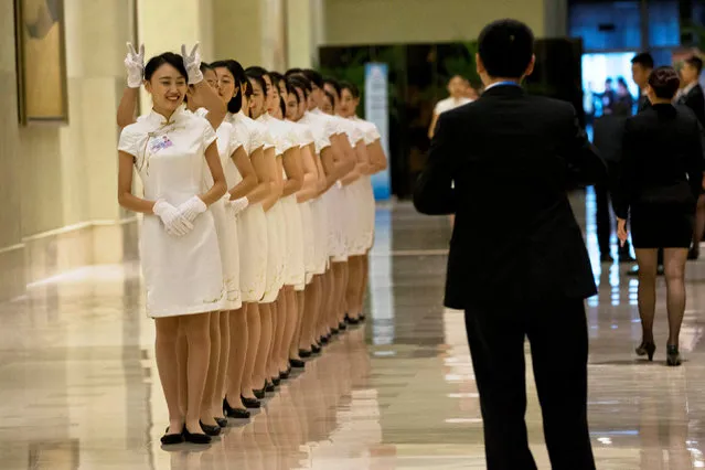 Hostesses pose for photos during a break from the G20 Finance Ministers and Central Bank Governors meeting in Chengdu in Southwestern China's Sichuan province, Sunday, July 24, 2016. (Photo by Ng Han Guan/Reuters)
