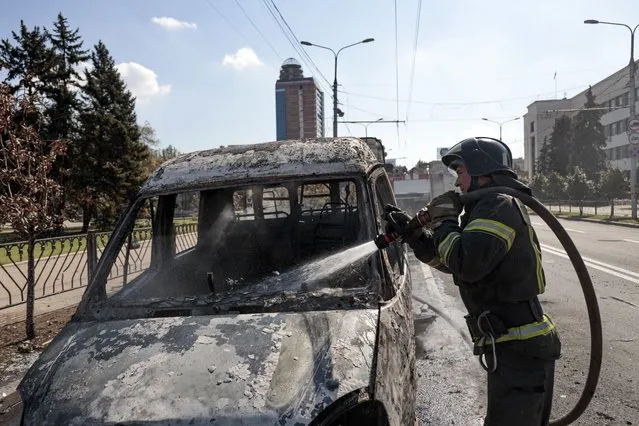 A firefighter extinguishes a burning vehicle after shelling in Donetsk, area controlled by Russian-backed separatist forces, eastern Ukraine, Saturday, September 17, 2022. (Photo by Alexei Alexandrov/AP Photo)